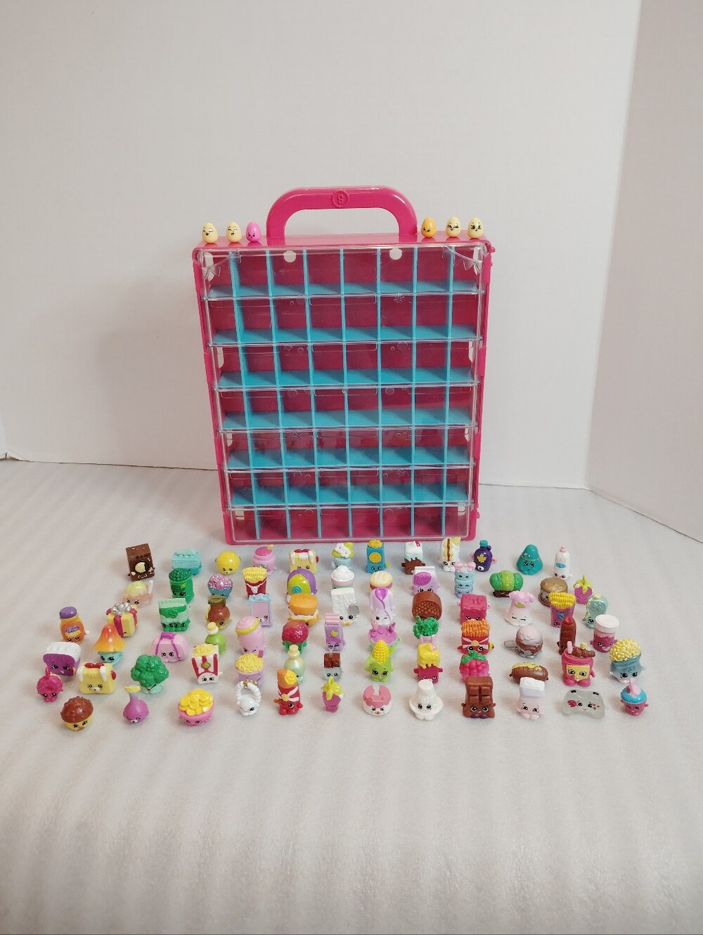 Shopkins Pink Carry Case with Blue Shelves and 75 Assorted Mini Figures